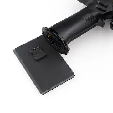 Close-up of Flysky Noble NB4 transmitter with battery pack, showcasing sleek design and components.